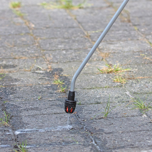 Spraying pesticide with portable sprayer